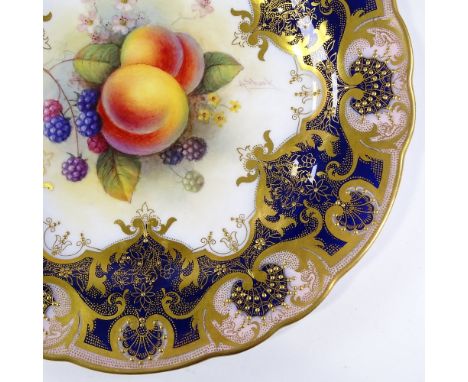 A Royal Worcester porcelain cabinet plate, with hand painted fruit design in textured gilded border, signed A Shuck, diameter