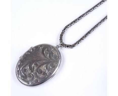 A large sterling silver oval photo locket, on long sterling silver birdcage link chain, pendant height excluding bale 56.2mm,