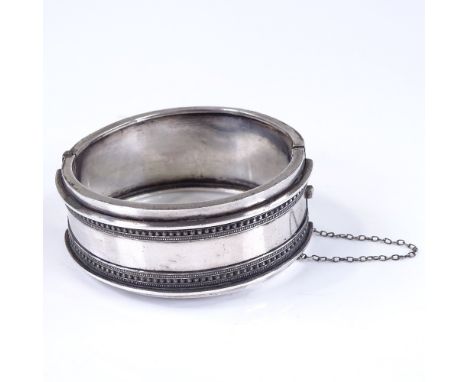 A Victorian sterling silver wide hinged bangle, band width 24.8mm, internal diameter 53mm, internal height 51mm, 33.8g 