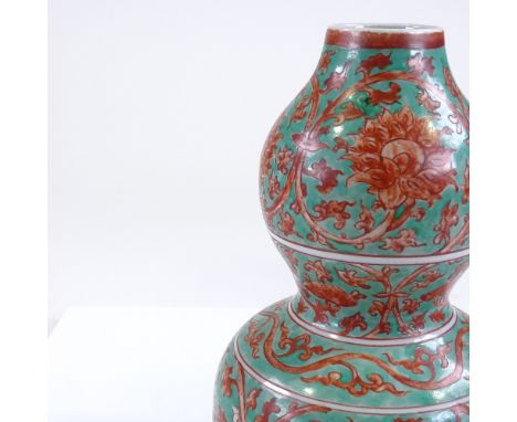 A Chinese porcelain double-gourd vase, with green and red painted floral decoration, 6 character mark, height 24cm 