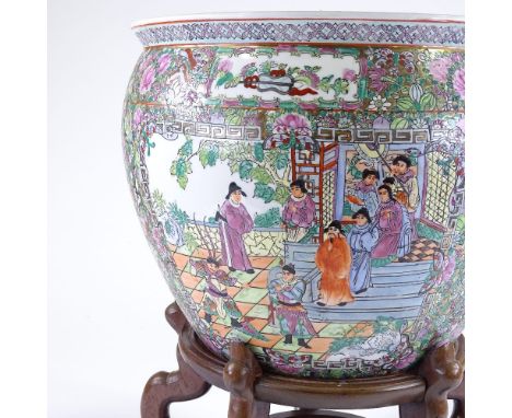 A Chinese famille rose porcelain fish bowl, with enamel decoration on wooden stand, rim diameter 37cm, height 50cm 