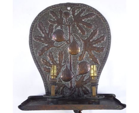 A Newlyn style Arts and Crafts copper wall light fitting, with relief fig tree decorated panel, height 32cm 