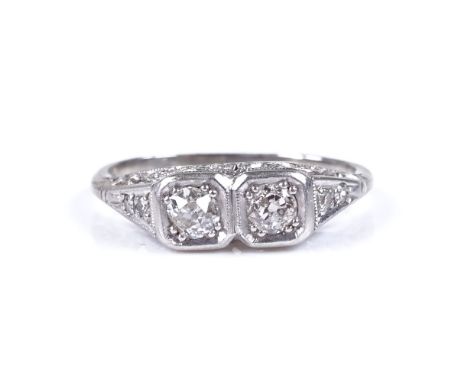 An 18ct white gold 2-stone diamond dress ring, with diamond set shoulders and pierced bridge, setting height 5.2mm, size J, 2