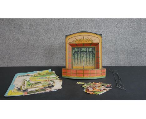 A vintage Pollock Adelphi toy theatre. Wooden structure secured with brass nuts and set screws, Bakelite proscenium and slidi