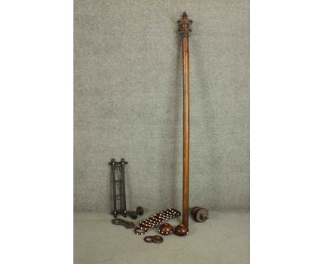 A Victorian fruitwood turned curtain pole with a set of eleven fruit wood curtain rings with white glass cabochon detailing, 