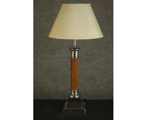 A Classical column style table lamp, with a reeded stem, and nickel plated mounts, on a square plinth base, with a cream shad