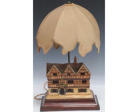 A Cecil Aldin ceramic model of a country inn 19.5 x 23 x 12cm, on a wooden plinth with raised lamp fitting, total height 49cm