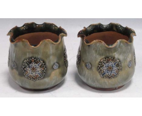 A pair of Royal Doulton stoneware miniature jardinieres with scalloped rims, the light green glazed bodies decorated with flo