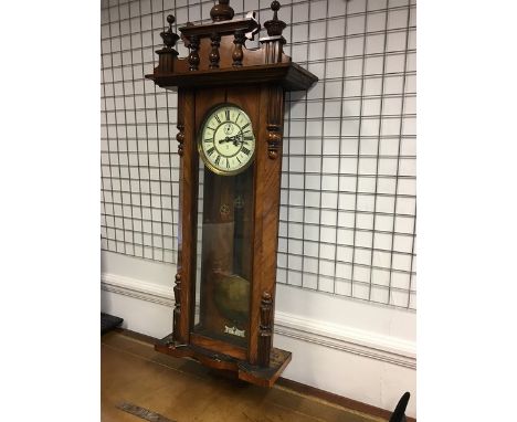 A Gustav Becker Vienna regulator wall clock, mahogany case with turned half baluster, vase and dome pediment, cream coloured 