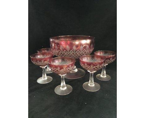 A ruby flashed glass pedestal bowl, cut through to clear with hobnail and palmettes; and five smaller pedestal bowls conformi