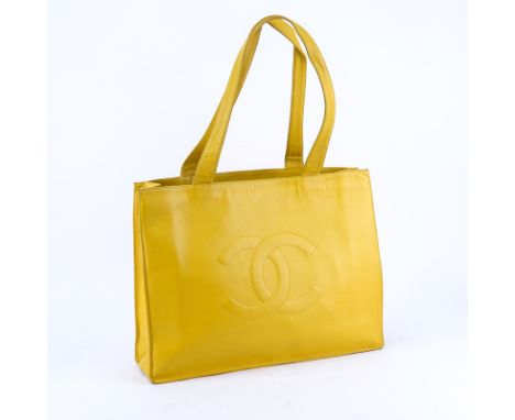 Chanel Yellow Caviar Leather Vintage Tote With Front Logo. Gold tone hardware. Interior with large zipper pocket. Labeled app