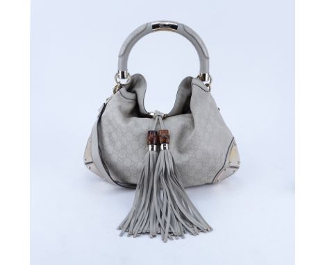 Gucci Beige Monogram Leather Indy Hobo Guccissima MM Bag. Gold tone hardware. The interior with patterned fabric, zipper and 