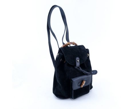 Gucci Black Suede And Leather Bamboo PM Backpack. Brushed gold hardware. Interior of signature fabric with zippered pocket. L