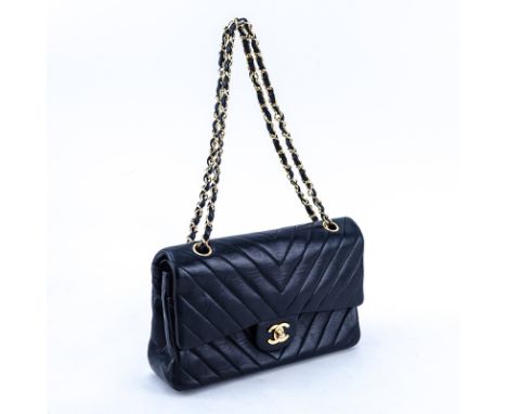 Chanel Black Quilted Chevron Motif Leather Double Flap Bag 23. Gold tone hardware. The interior of burgundy leather with patc