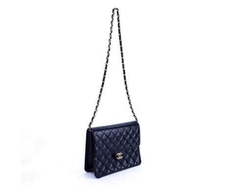 Chanel Black Quilted Leather Mademoiselle PM Handbag. Gold tone hardware. The interior of burgundy leather with zippered pock