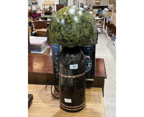 A Howitzer Dopp Z c.91 shell based table lamp with helmet shade.