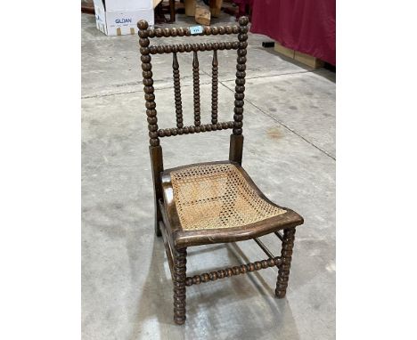 A Victorian bobbin turned chair with caned seat.