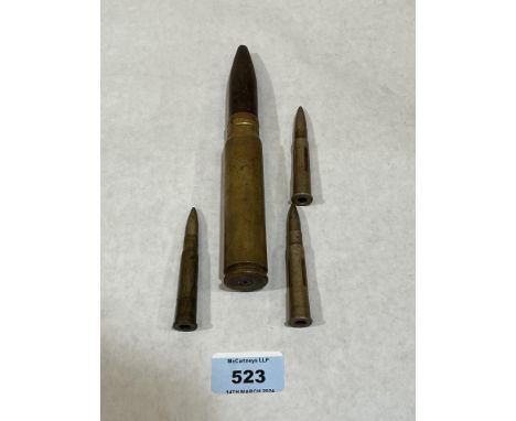A 20mm ammunition cartridge and three smaller.