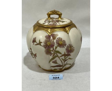 A Royal Worcester blush ivory jar and cover, gilded and painted with flowers. Shape 1412. 6½" high.