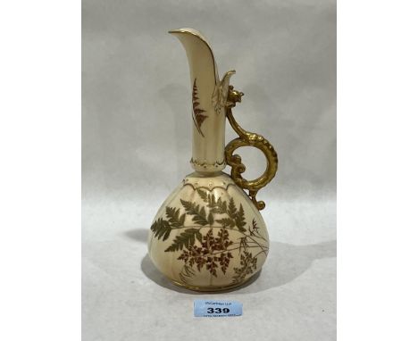 A Royal Worcester blush ivory ewer, gilded and painted with foliage. 8½" high.