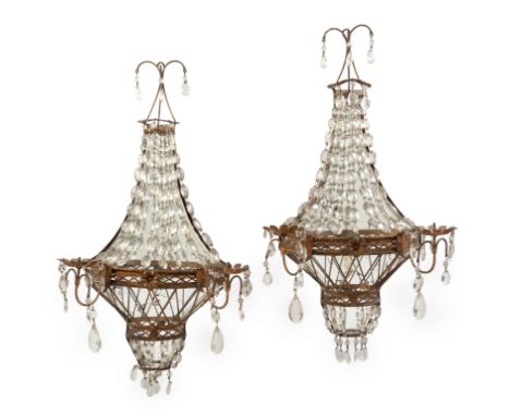 A pair of French gilt-iron twin-light wall appliques,&nbsp;late 20th century -&nbsp;each with mirrored back-plate and hung wi