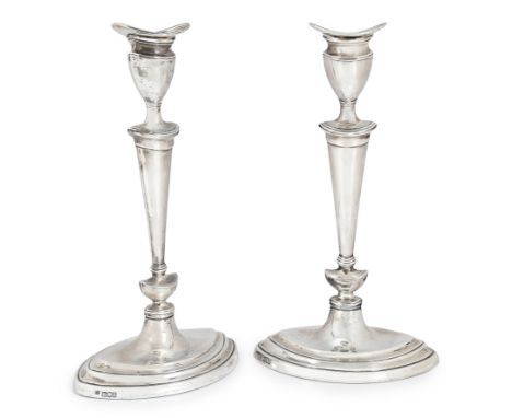 A pair of George V silver candlesticks,  Thomas Bradbury & Sons, London, 1916;   Designed with oval bases to knopped stems an
