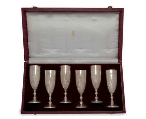 A cased set of six silver champagne flutes,  Asprey & Co., London, 1993;   The plain bodies raised on knopped stems to moulde