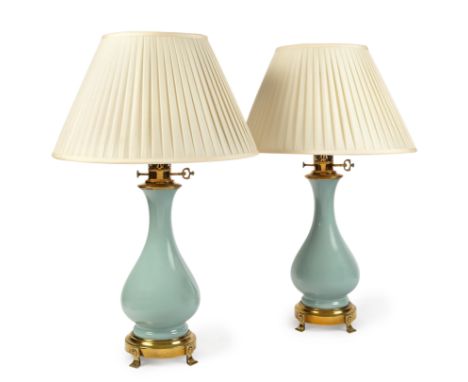 A pair of brass-mounted pale blue glazed table lamps,  late 20th century -   each with each with faux oil burner fitment and 