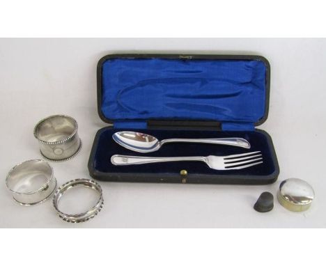 Collection of silver to include Henry Williamson cased spoon and fork, napkin rings, pill box etc - total weight 3.61ozt