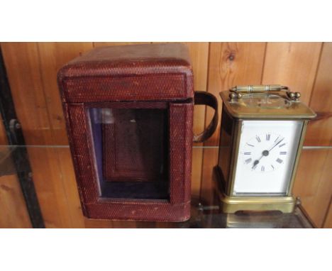 A brass carriage clock striking on a bell with travel case - Height 13cm - working but strike needs attention