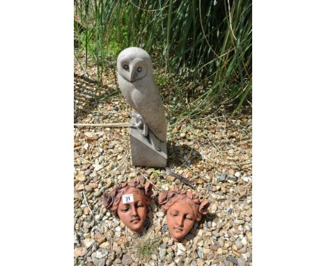 A life sized cast stone figure of a barn owl - Height 41cm - together with a pair of girls with flowers wall pocket/planter -