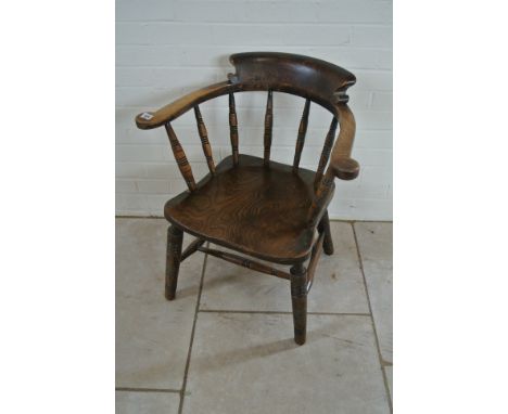 A late Victorian ash and elm smokers bow armchair - reduced in height