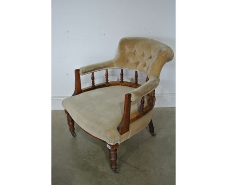 A late Victorian button back tub chair with turned supports
