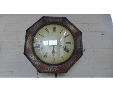 A brass inlaid wall clock with white enamel dial with Roman numerals