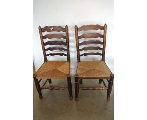 A pair of 18th century oak ladder back chairs
