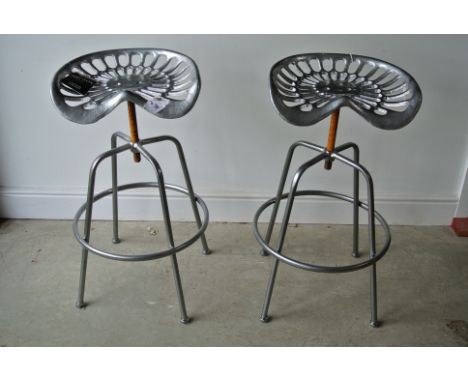 A pair of modern Ascalon tractor seat bar stools