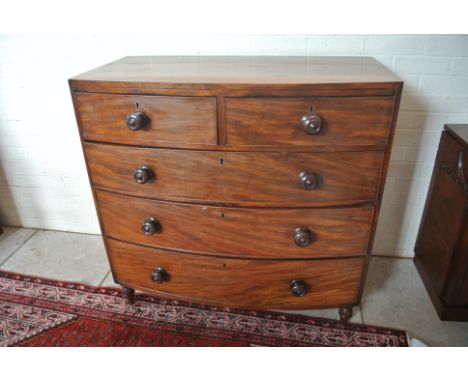 A Victorian mahogany bow front chest of two short over three long drawers raised on turned supports - Height 101cm x 101cm x 