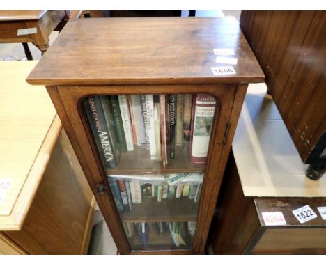 Single glass fronted cabinet with a selection of hard and paper back volumes. Not available for in-house P&amp;P 