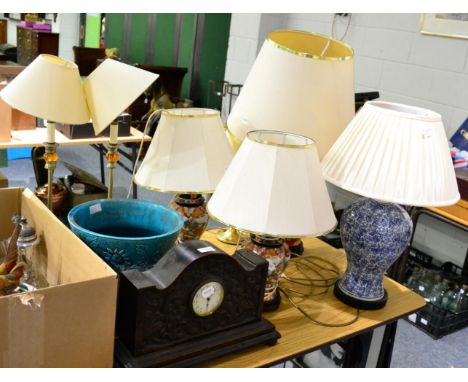 A carved oak mantle clock and a Burmantofts jardiniere and seven various table lamps  