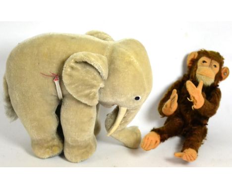 Circa 1968, Steiff grey standing elephant (lacking red saddle), 20cm high and a 1950's Steiff  'Jacko' brown mohair monkey/ch