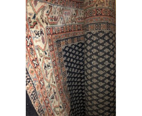 20TH CENTURY WOOLEN FRINGE CARPET WITH PATTERNS ON A BLUE GROUND 