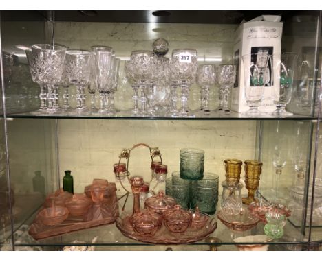 TOP SHELF OF SETS OF DRINKING GLASSES AND THE SECOND SHELF OF COLOURED GLASSWARES