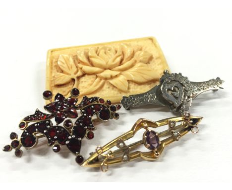 A 9ct gold Amethyst and Seed Pearl set bar brooch together with a garnet set brooch and two other brooches.
