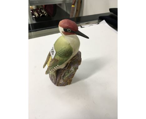 A hand painted Royal Worcester bone china model of a Woodpecker (model mo. 3249), signed RB.