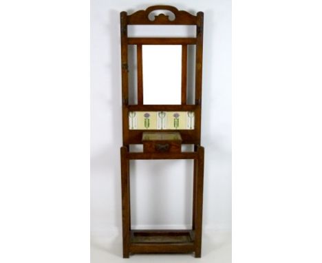 An early 20th century oak hall stand, with rectangular mirror over tiled back, lidded trinket box, drip tray below, 61 by 27 