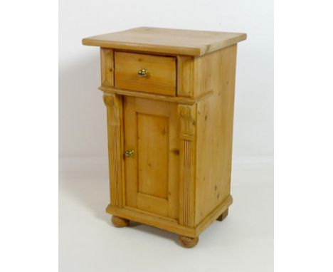 A Continental stripped pine pot cupboard, with single drawer over cupboard door, with brass knobs,single shelf, raised on fla