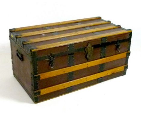 A vintage steamer trunk, oak bound with metal fittings, black painted carry handles, no key, 82 by 42 by 38cm high.
