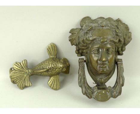 A brass door knocker in the form of a flying koi carp fish, 12 by 6 by 16cm, and a French reproduction door knocker in the fo