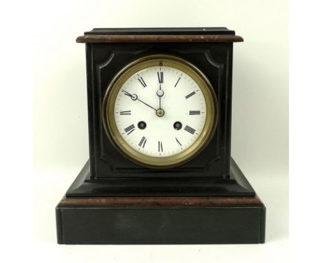 A slate mantel clock, the white dial with black Roman numerals, movement chiming on a bell, 22 by 16 by 23cm. 