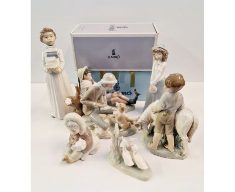 Four Lladro and five Nao figures.